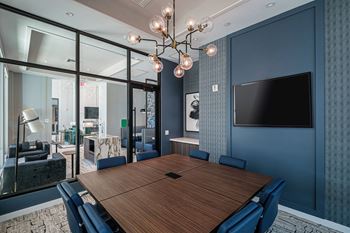 A conference room with a long table and chairs.